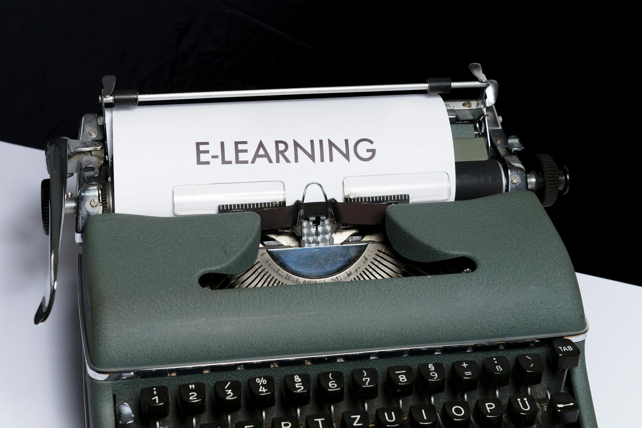 Close-up of a vintage typewriter displaying the concept of e-learning on paper.